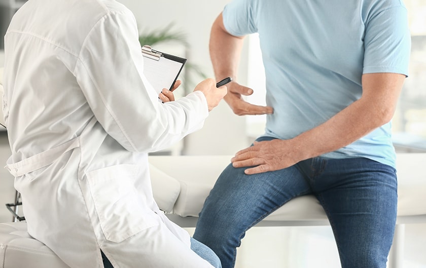 Image of man visiting doctor pointing put pain