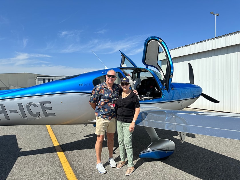 Jan Hinchliffe and Dr Andrew Dean standing in front of a small plane