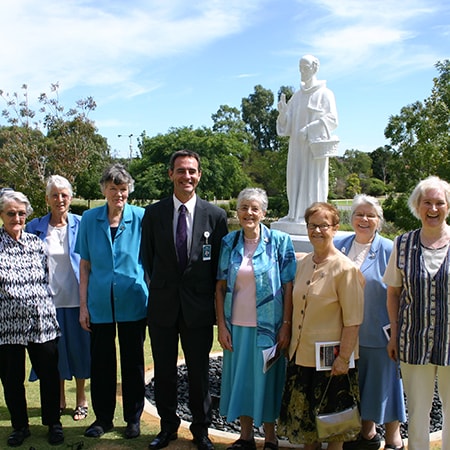 Seven Sisters of St John of God stand with St John of God Murdoch Hospital Chief Executive Officer Peter Mott in front of the statue of St John of God at Murdoch on 8 March 2010