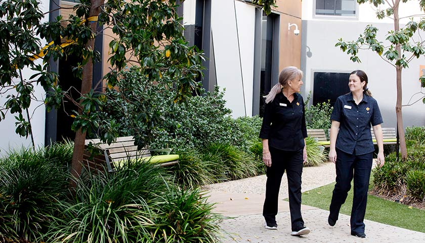 Caregivers walking through the grounds of St John of God Bendigo Hospital