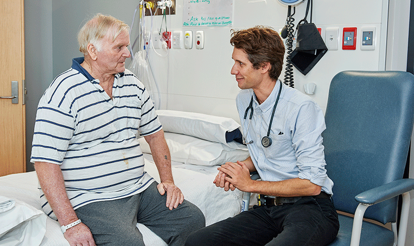 Doctor talking to patient in hospital