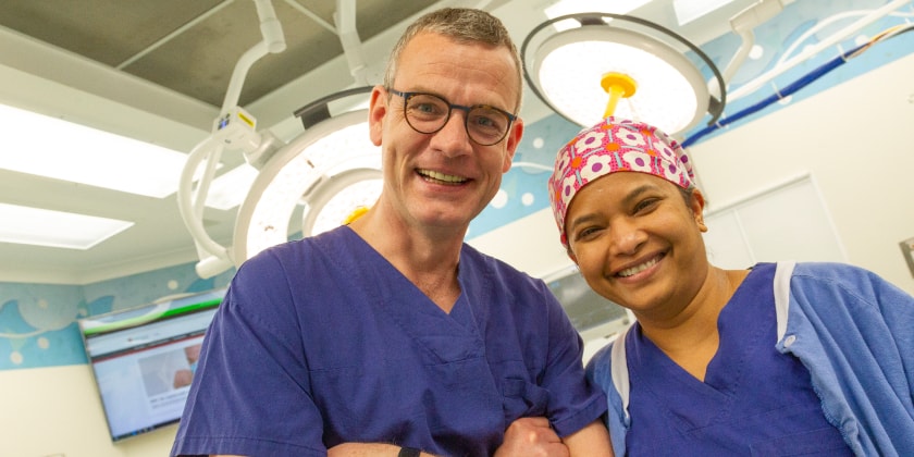 Two specialists smiling in surgical theatre