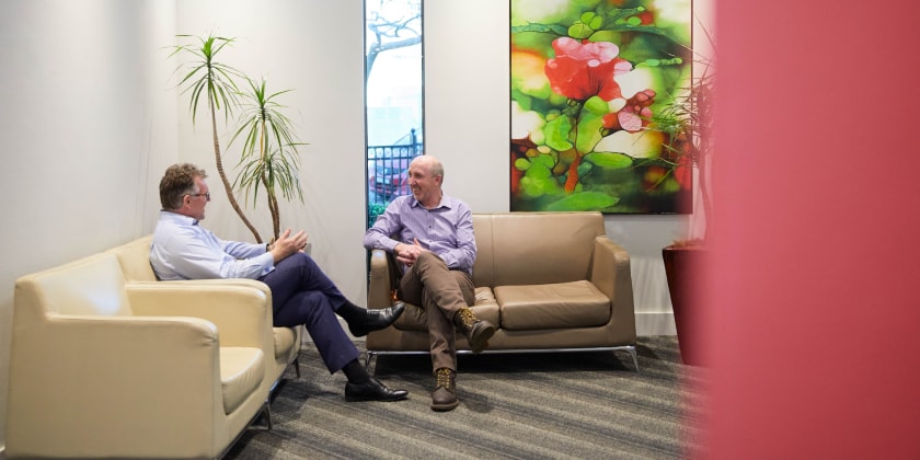 Two specialists talking while seated in suite