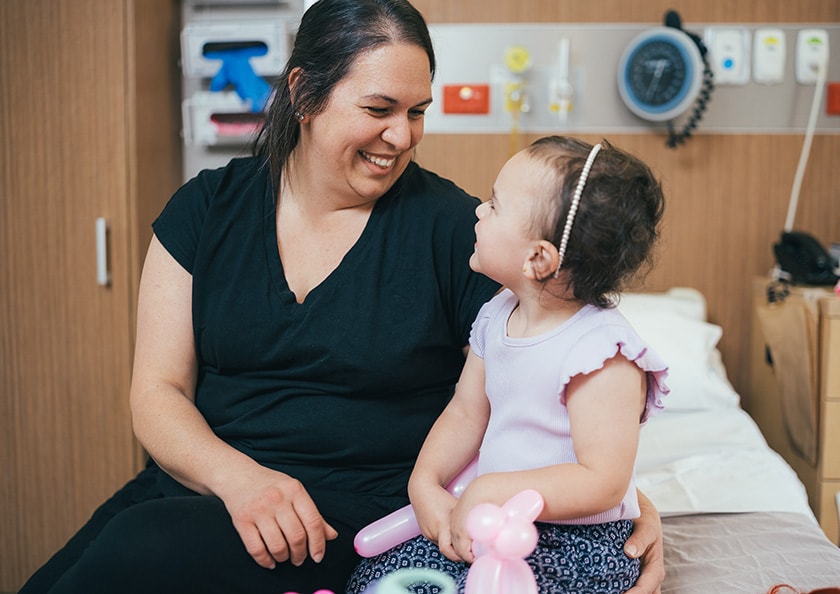 Parent and child smiling in private hospital room