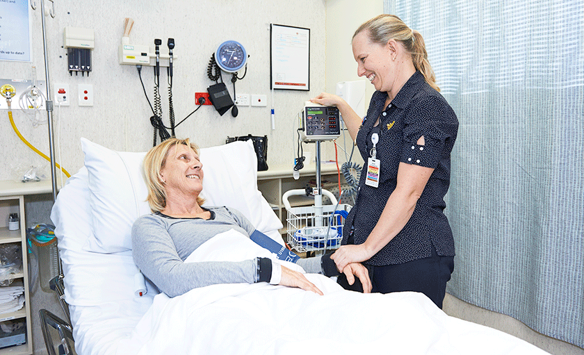 Nurse with patient in bed