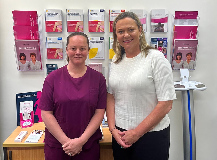 McGrath Breast Care Nurse, Shanya Beattie and St John of God Bendigo Hospital Director of Nursing, Liz McEncroe standing in front of a cabinet, with pamphlets on the wall behind them.