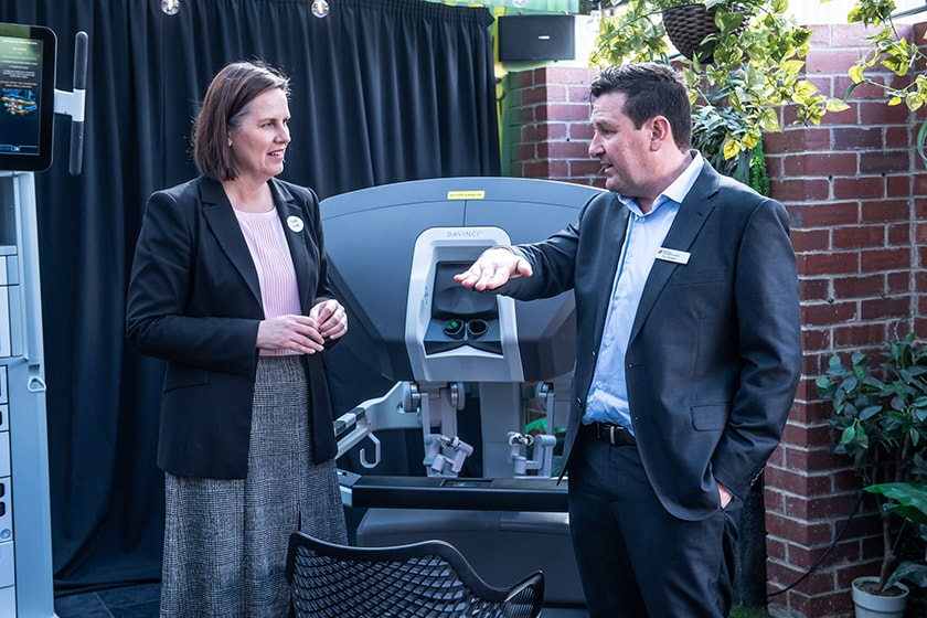 Gaelle Broad MP, MLC for Northern Victoria with Tim Grogan Device Technologies standing in front of the da Vinci Xi robot at Mackenzie Quarters Bendigo
