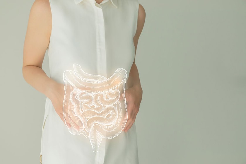 A diagram of a GI tract laid over a real photo of someone holding their stomach