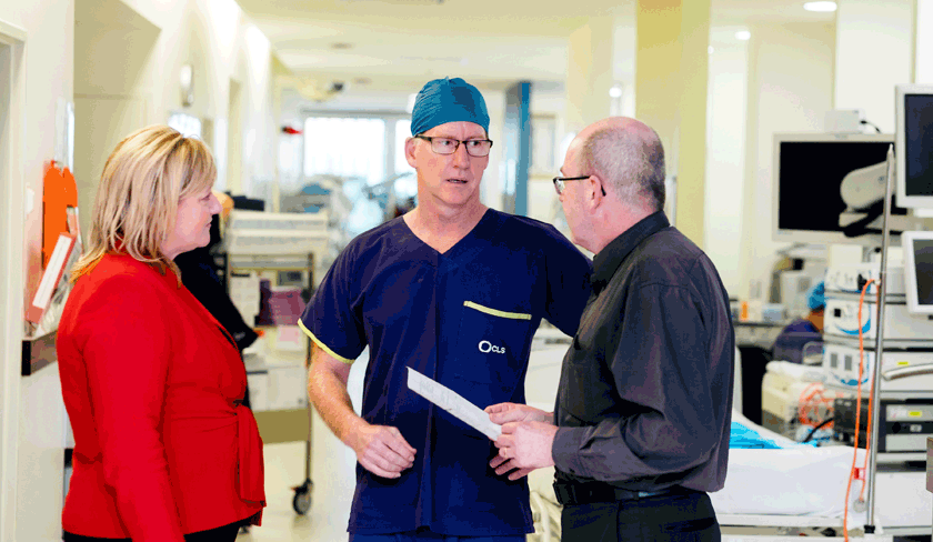 Doctors consulting with each other in corridor