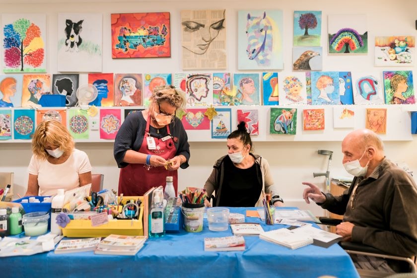 Caregiver and patients in art room