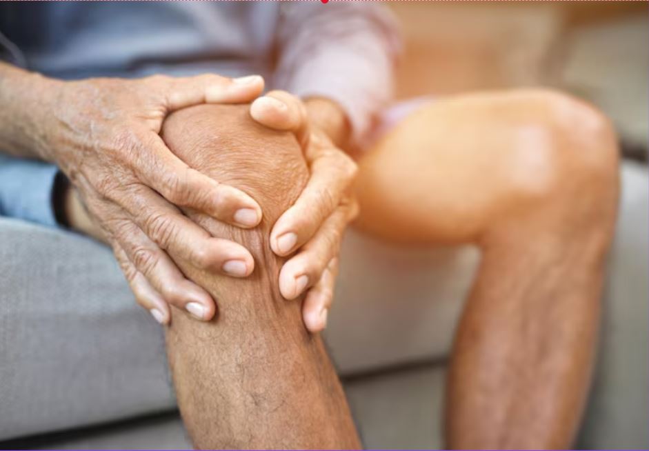 A person holding their knee