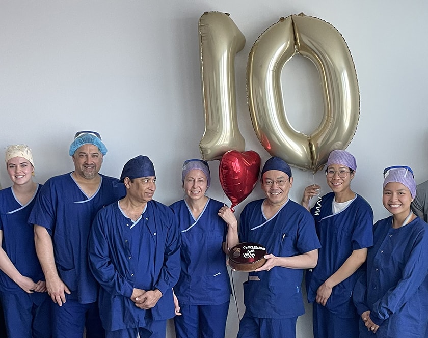 The cardiac team at St John of God Geelong Hospital smile with a giant 10 baloon and celebratory cake