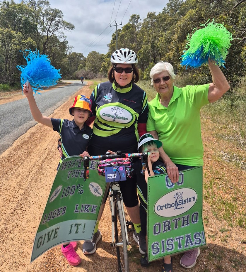 a member of the Ortho Sistas on her bike