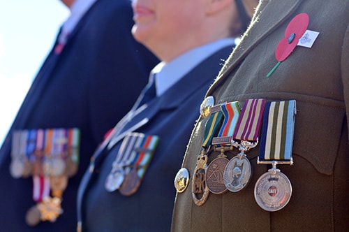 Three Australian Defence Force members in official military uniform with badges of honour