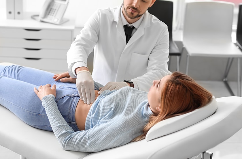 A gastroenterologist examines a patients stomach