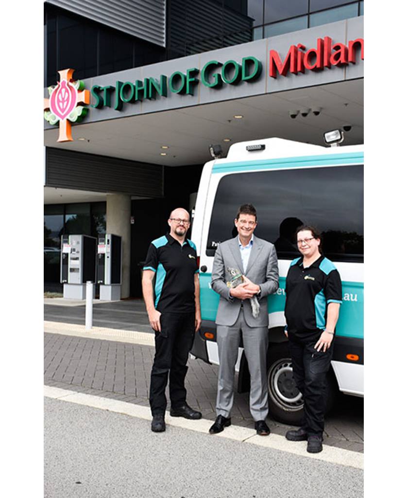 St John of God Midland Public and Private Hospital Chief Executive Officer Paul Dyer with representatives from Ambulance Wish WA standing outside the hospital