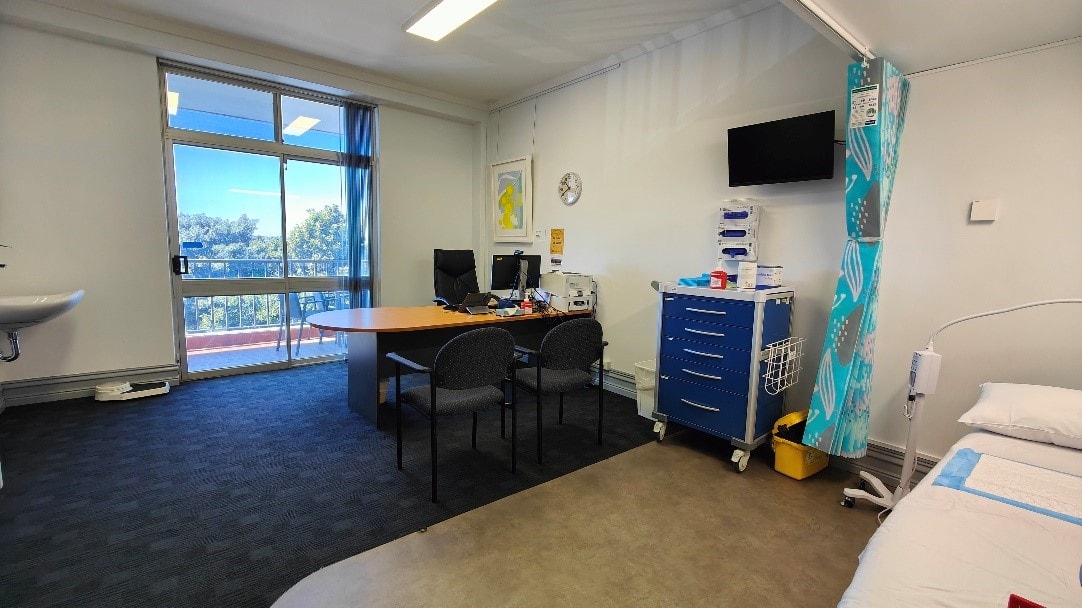 A sessional suite comprising of examination bed, desk, chair and computer.