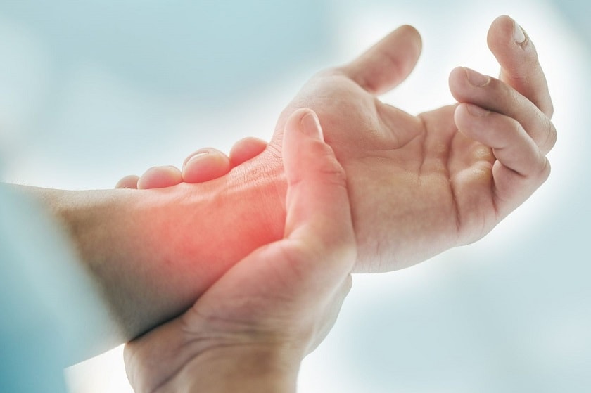 Set of hands with the right hand holding the wrist of the left hand.