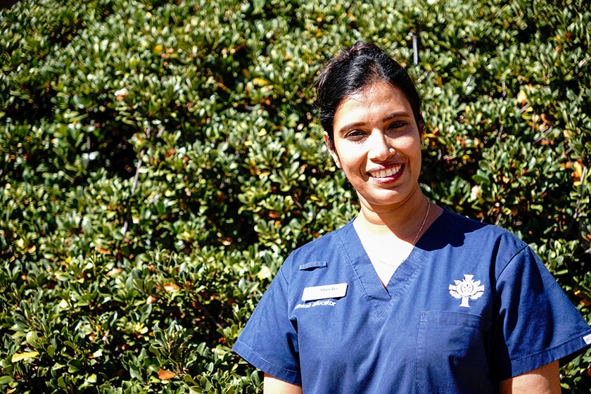 Caregiver Sheeba Abraham smiling at the camera.