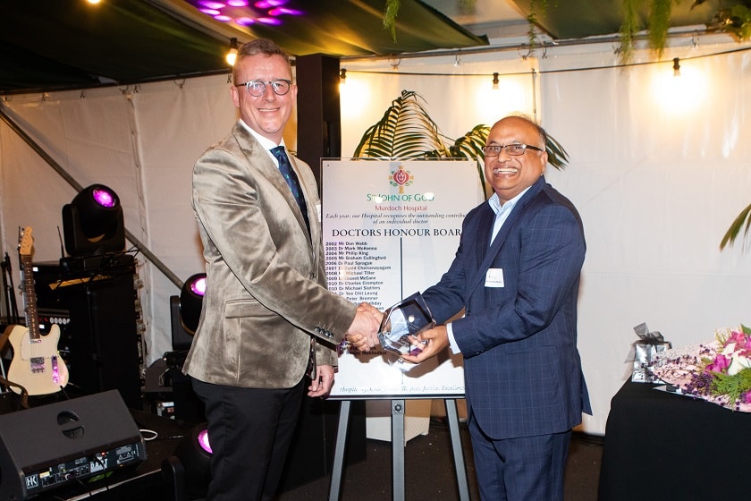 St John of God Murdoch Hospital CEO Ben Irish presenting Dr Sanjay Mukhedkar with his award.