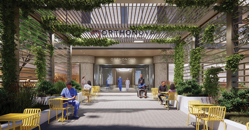 A computer generated render of the entrance to the new Orthonova building. A plant lined awning covers a walkway leading to the front doors with people sitting at yellow tables and chairs along the side of the walkway.