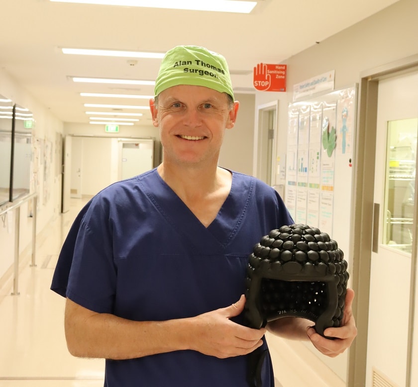 Mr Alan Thomas, General Surgeon at St John of God Murdoch Hospital holds the NIA helmet