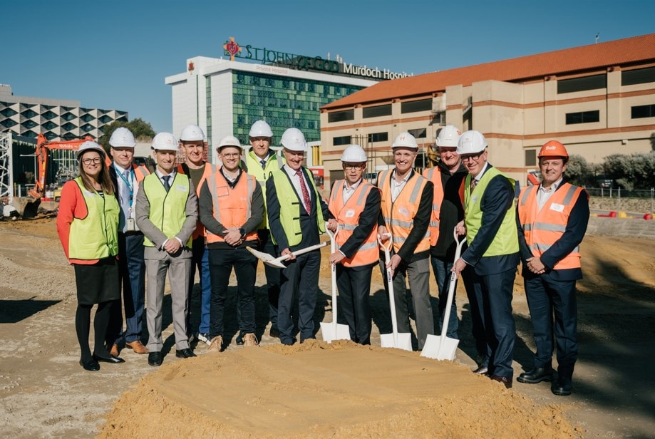 People standing in hi-vis vests at the sod-turning ceremony for the Orthonova Orthopaedic Hospital.
