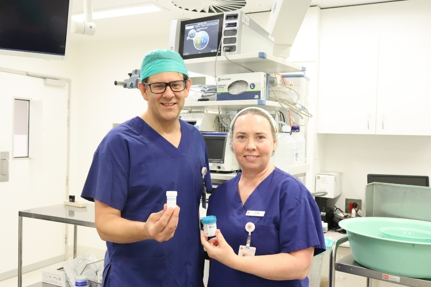Dr Oliver Waters showing a 25ml histopathology pot and Clinical Nurse Carla Hazelgrave showing a 70mL histopathology pot