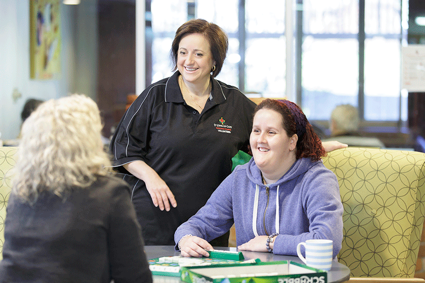 Volunteer talks to patients