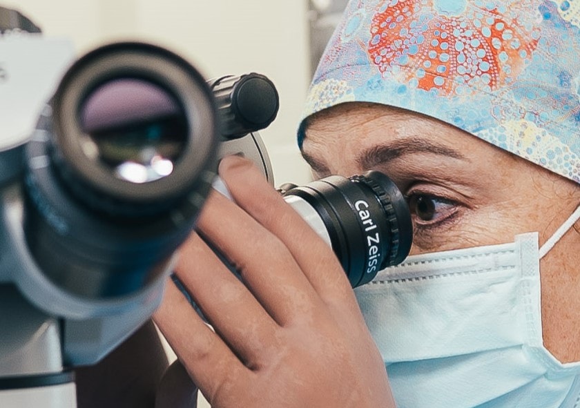 Female doctor looking through lens before surgery