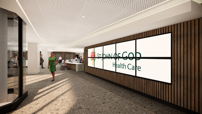 Artists impression showing the proposed upgraded main entrance lobby to St John of God Subiaco Hospital with LED screens showing the St John of God Health Care logo and brown wall cladding.
