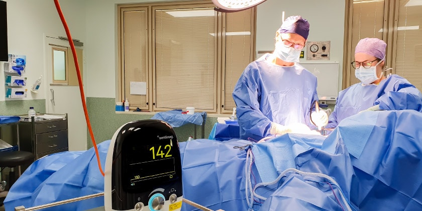 Caregivers in scrubs operating in theatre.  