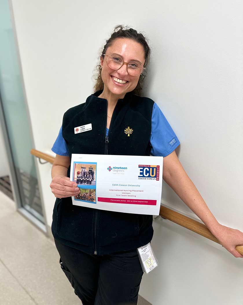 Assistant in Nursing Taryn Le Roux smiles while holding up her Vietnam placement paperwork.