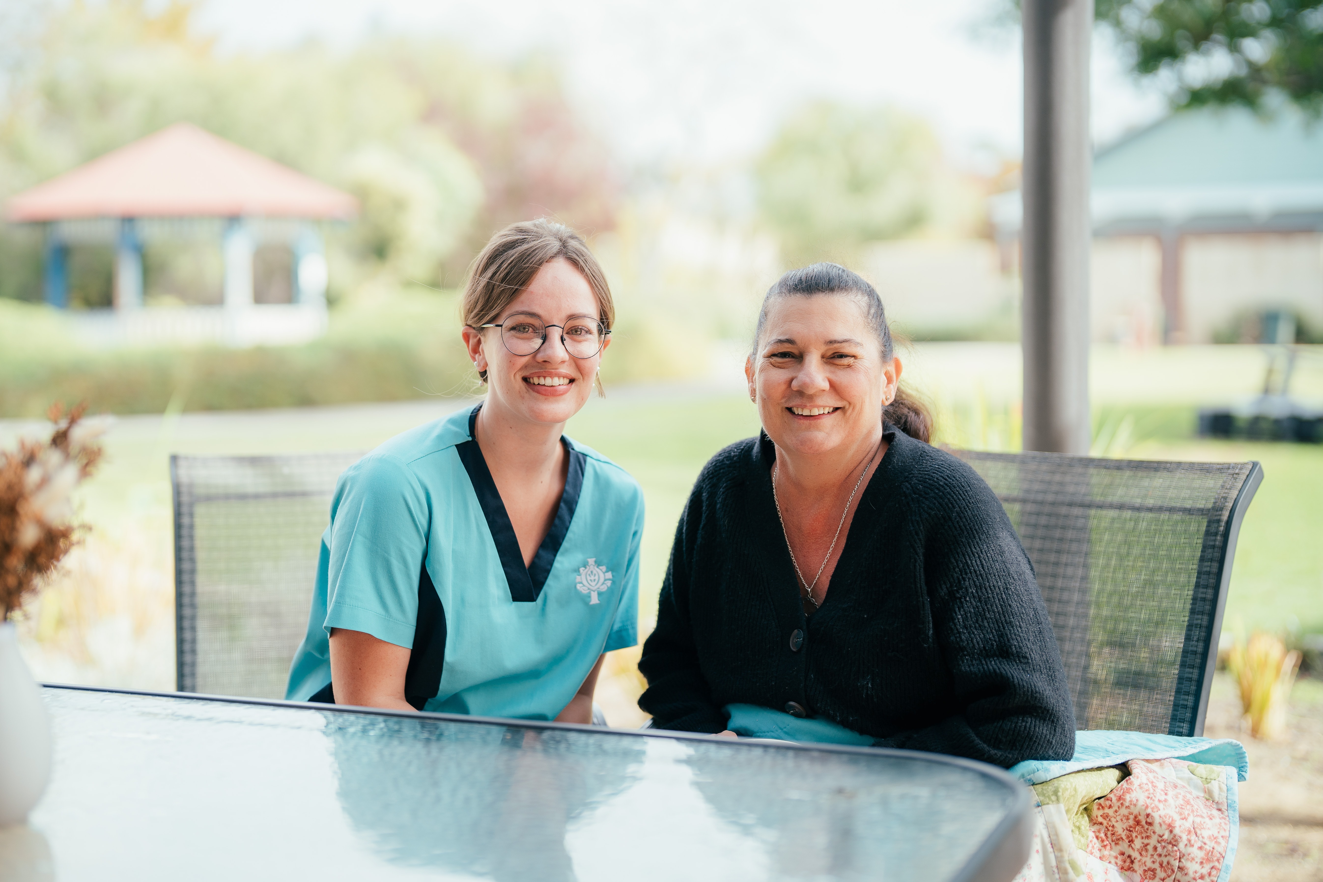 To caregivers seated at a table at Bunbury 