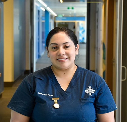 Image of Graduate Nurse Wendy, standing in the hallway of St John of God Midland