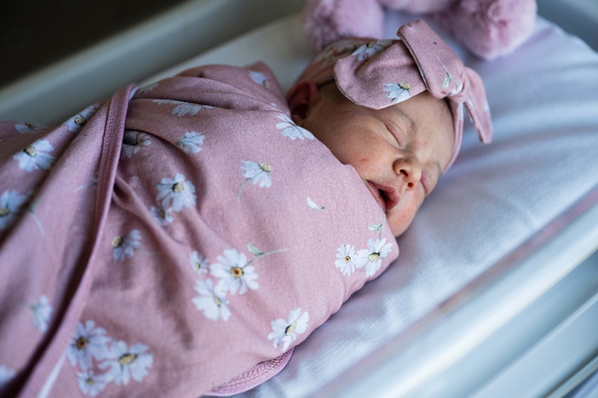Baby swaddled lying in a cot sleeping