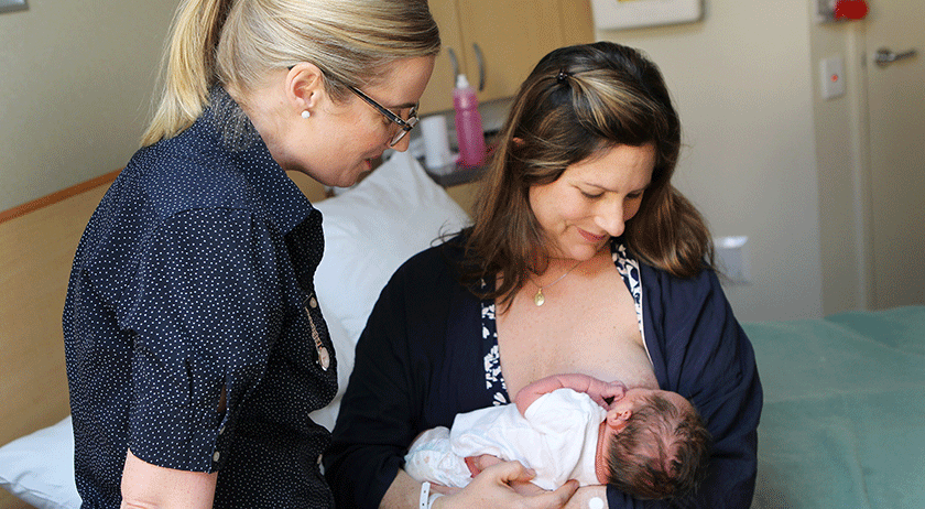 Midwife giving breastfeeding and lactation support to new mum