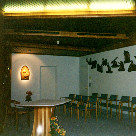 Interior of Chapel showing table, chairs and artwork on walls