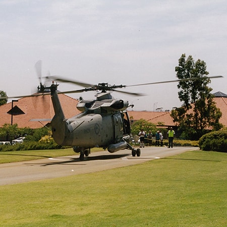 Grey helicopter sits on the St John of God Murdoch Hospital emergency helipad