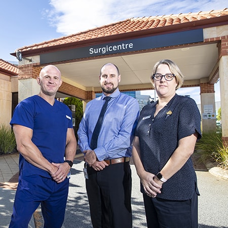 St John of God Murdoch Hospital Chief Executive Officer Ben Edwards, Oliver Brennan and Kelli Dawson standing in front of the Surgicentre