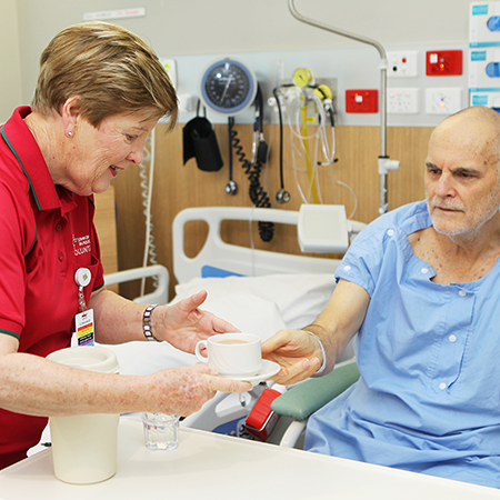 Volunteer helping patient 