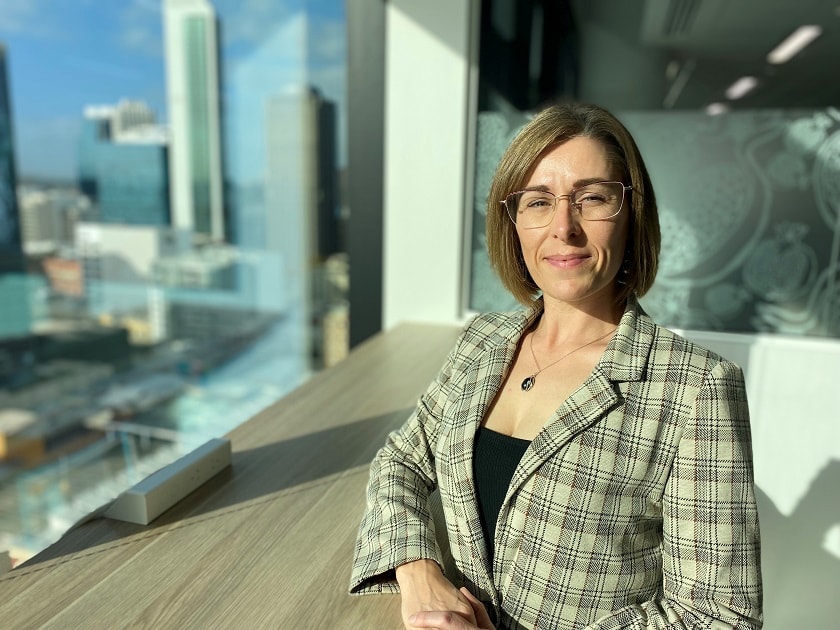 Blog author Naomi Boyd looking at the camera in a high rise building.