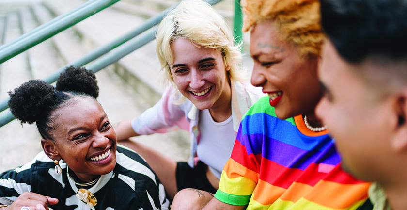 Lgbtqia+ friends talking sitting on a staircase outdoors