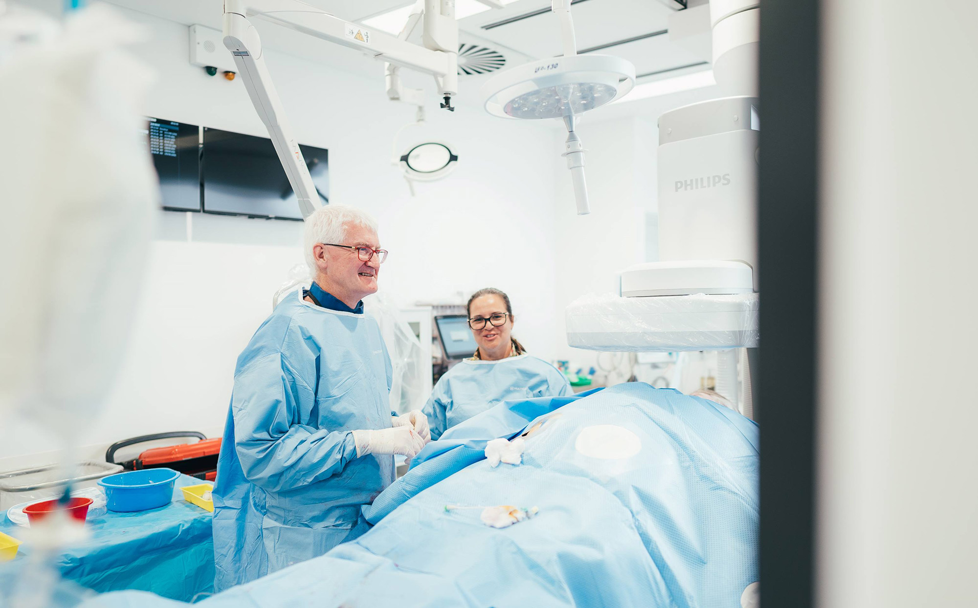 A caregiver comforts a bariatric surgery patient before his procedure