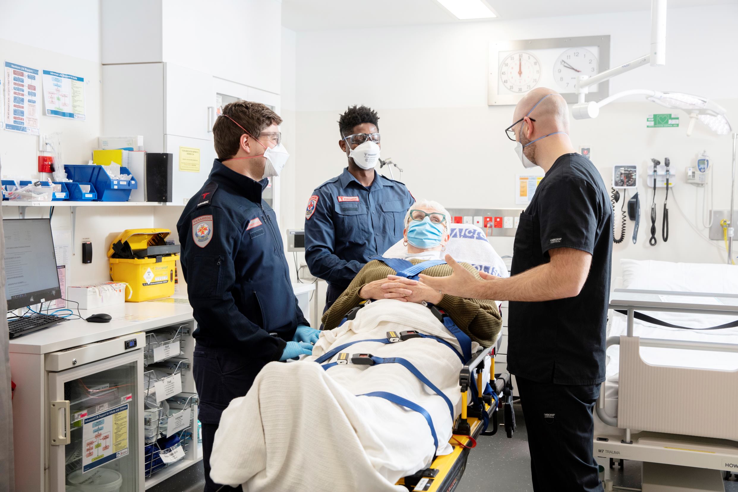 Patient in emergency department with caregivers and specialist discussing their care.jpg