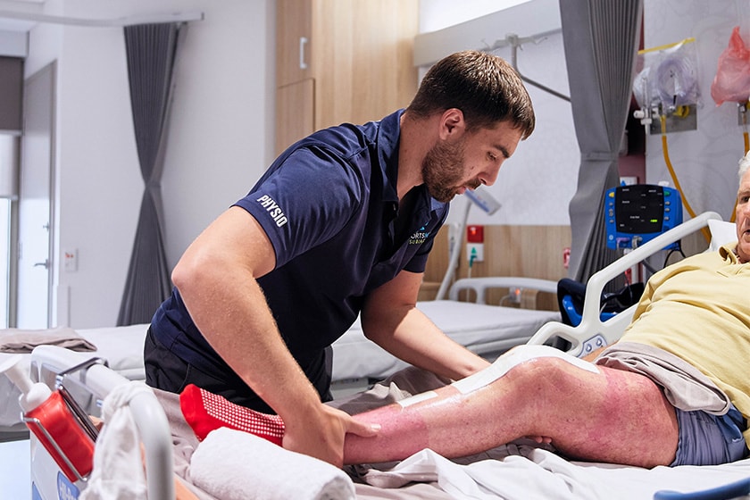 Physio working with an elderly man