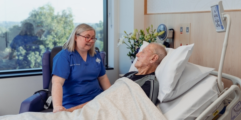A caregiver comforts a bariatric surgery patient before his procedure