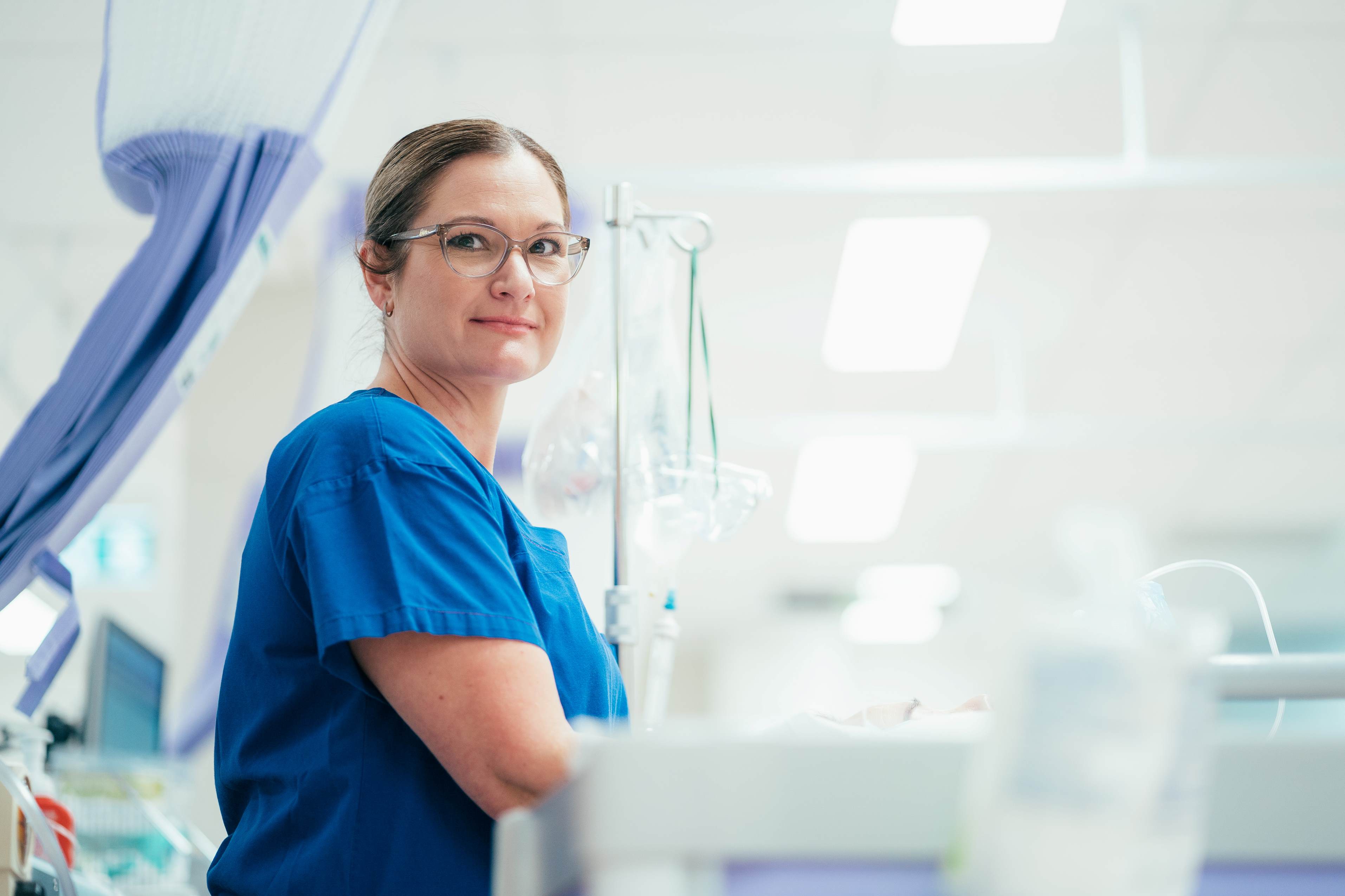 Caregiver in uniform working with medical equipment