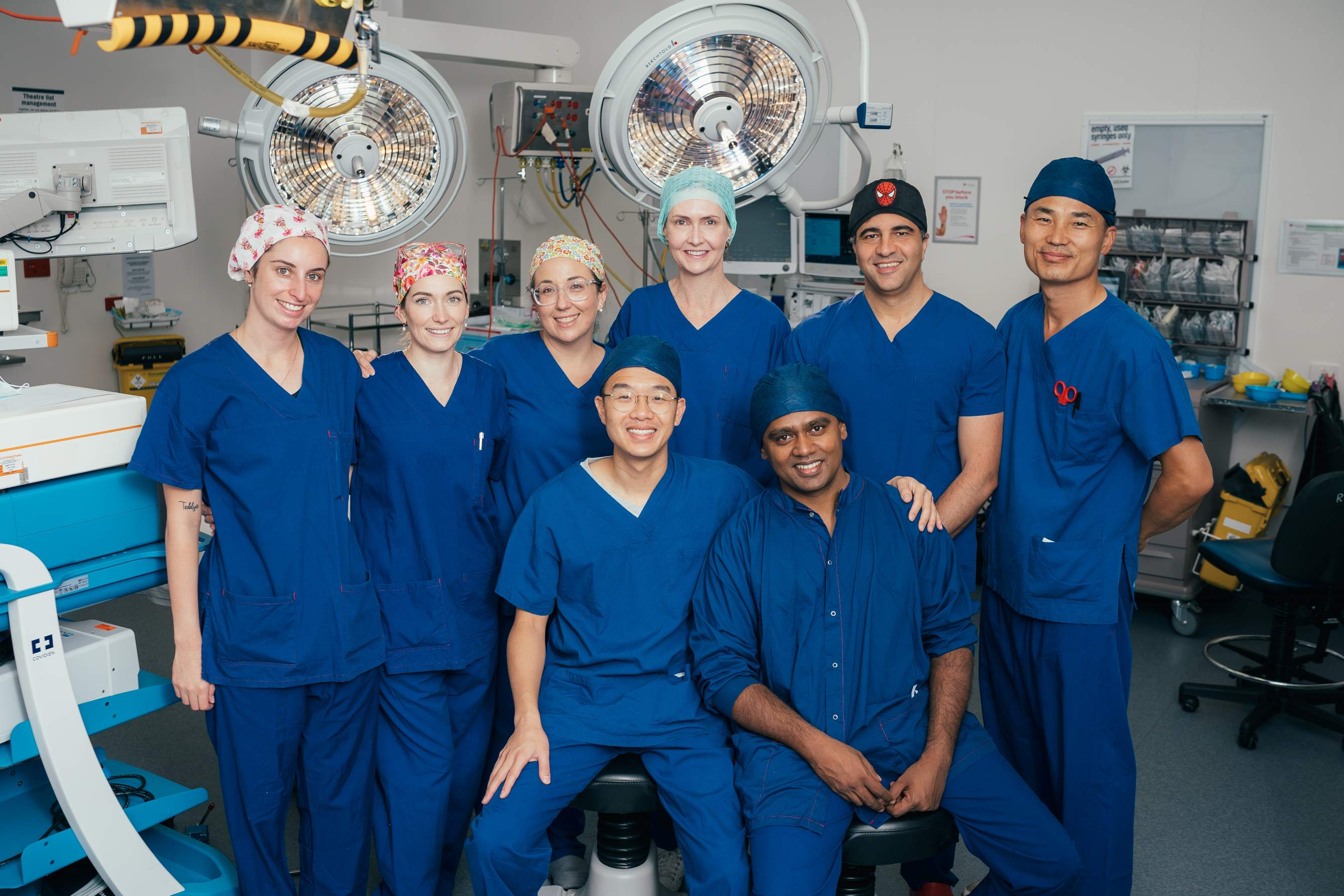 Group of specialists and caregivers in operating theatre