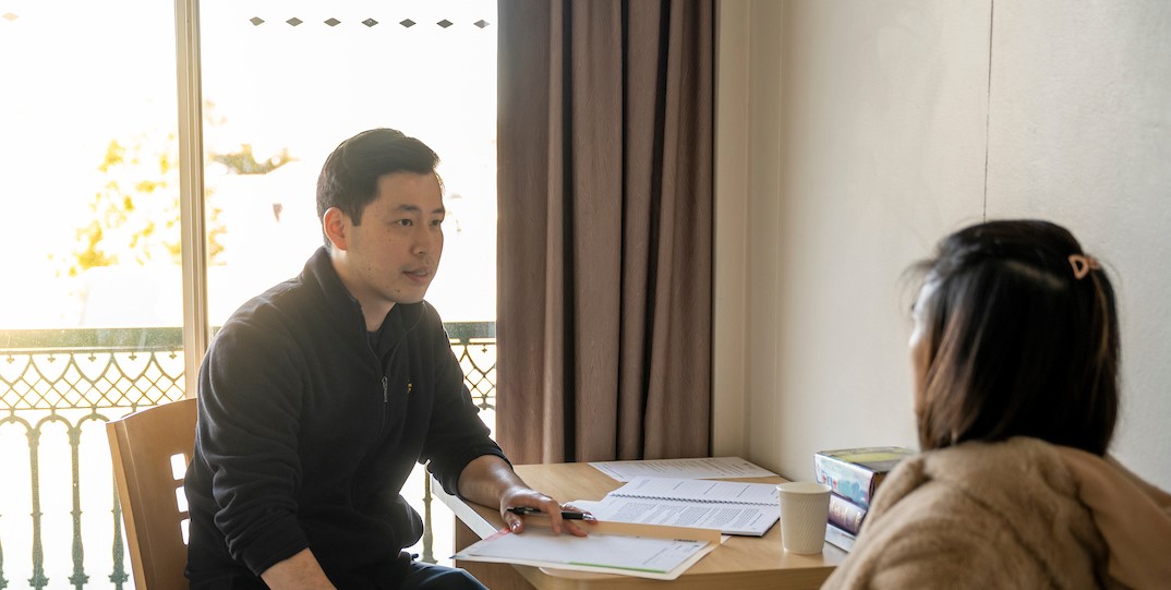 Two people in discussion over paperwork.jpg